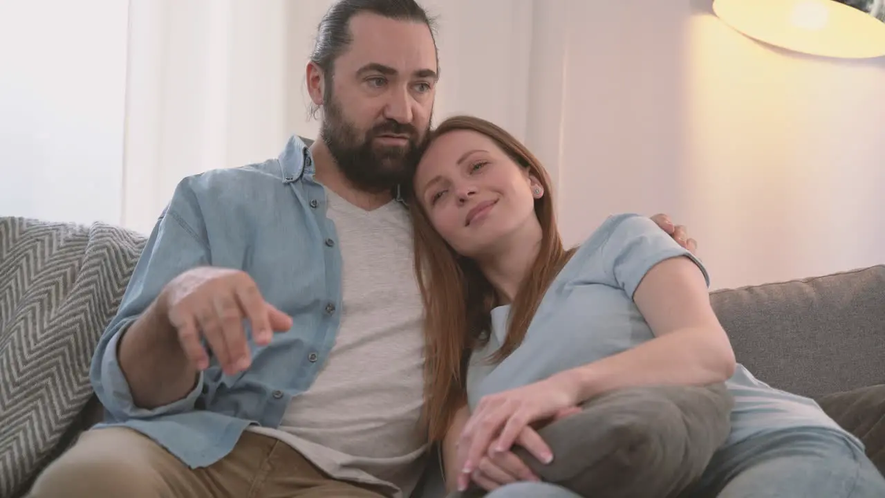 Bearded Man Converses With His Partner An Attractive Woman Who Rests Her Head On His Shoulder