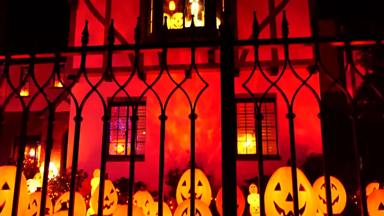 House decorated with lighted jack-o'-lanterns for Halloween