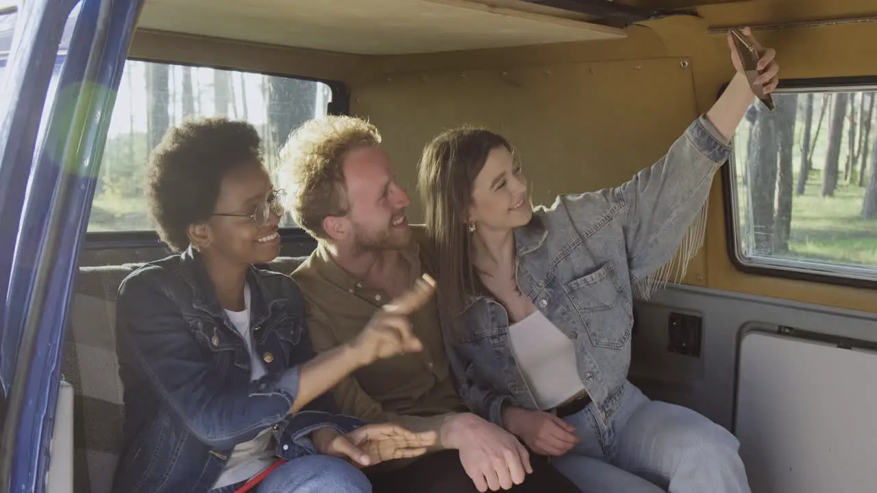 Three Friends Take A Selfie Of Them Inside A Caravan During A Roadtrip