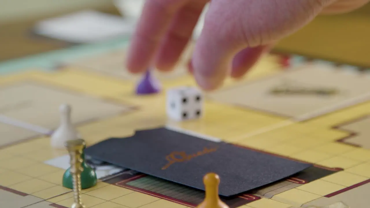 Close Up Hand Rolling Die in Cluedo Board Game