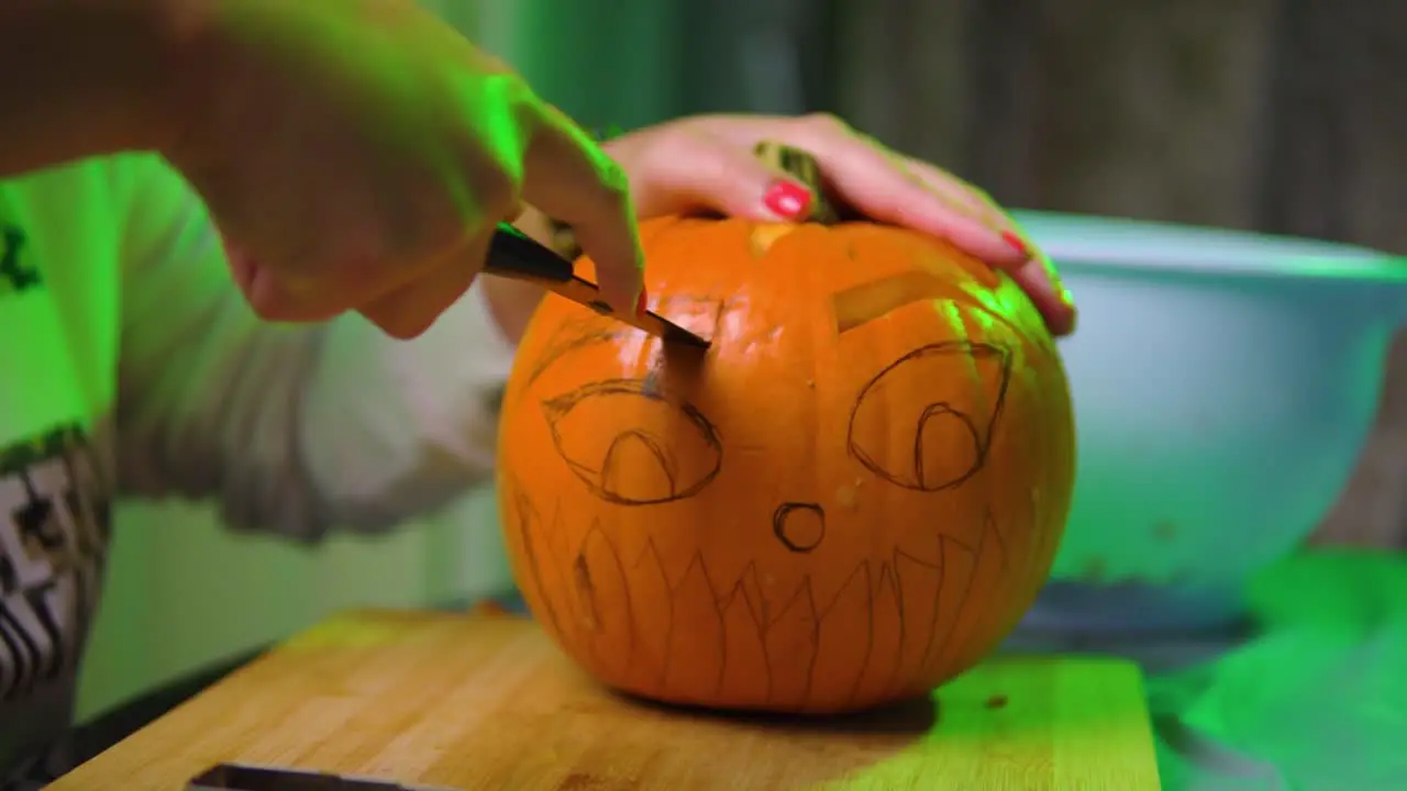 Cutting out eyebrow shape from a pumpkin in slowmotion