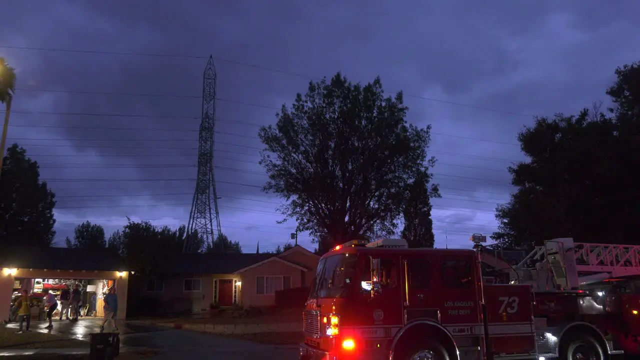 Fire trucks on scene during a stormy night