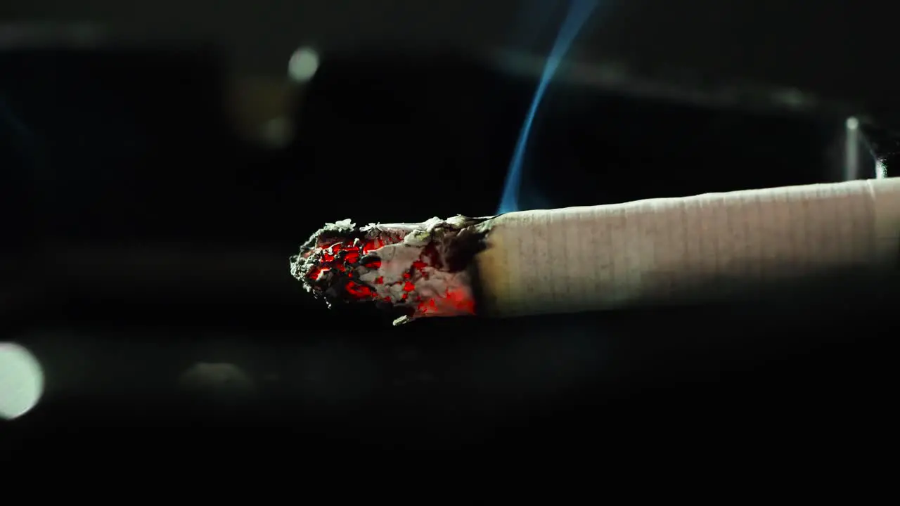 Close up smoking cigarette on man hand