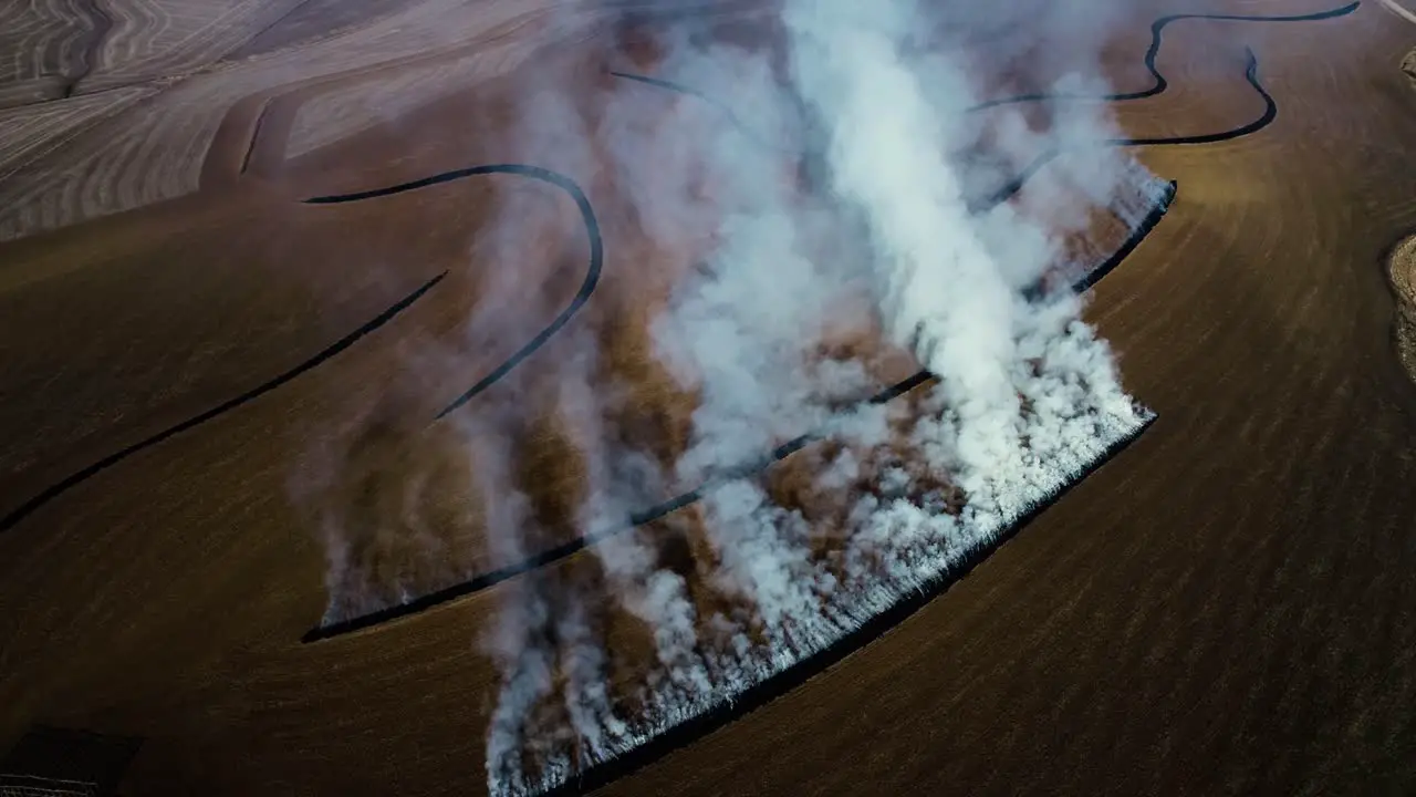 Aerial view of farmer burning terraces with big smoke clouds