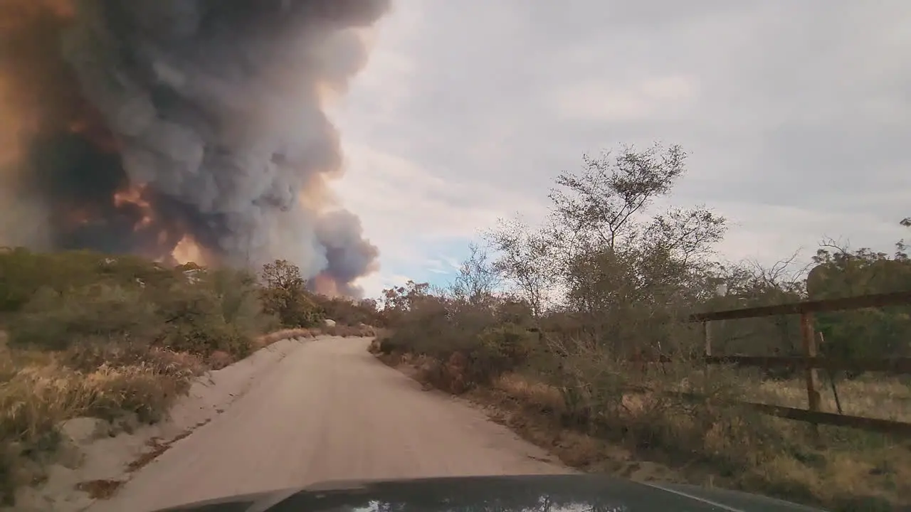 Large dark gray and orange smoke pillar from wildfire