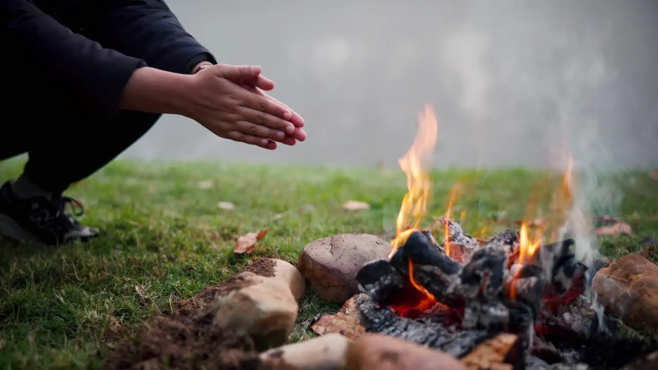 Bonfire wood and camping with warm hands