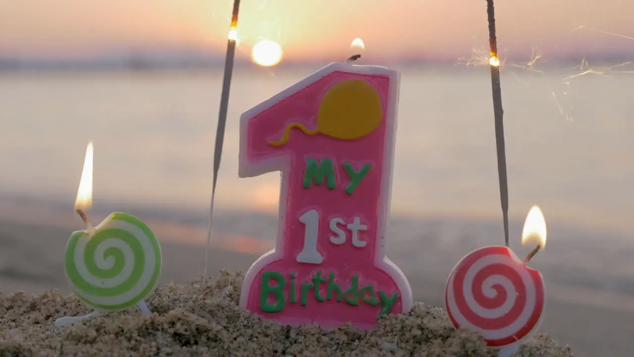 Baby girl first birthday candle on the beach