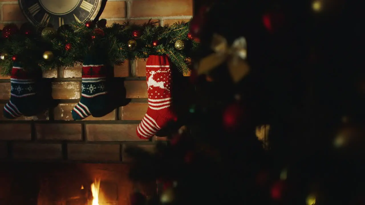 Christmas gift socks hang over the fireplace where the fire burns 4