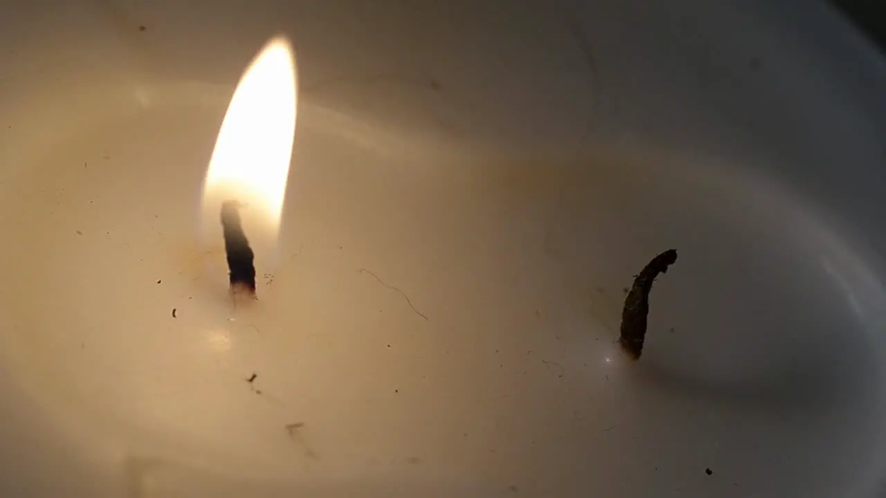 White candle burning one flame