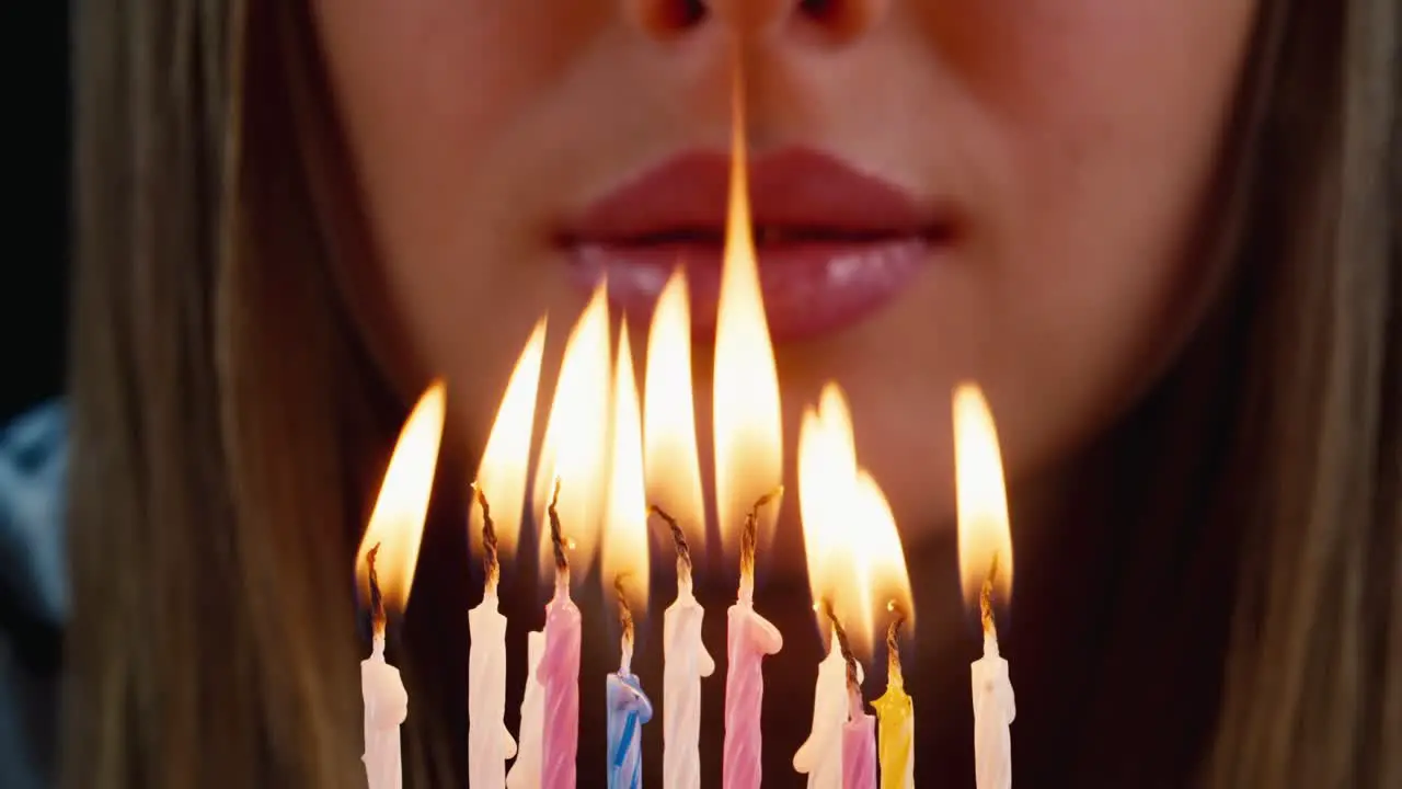 Birthday boy blows out candles on a birthday cake