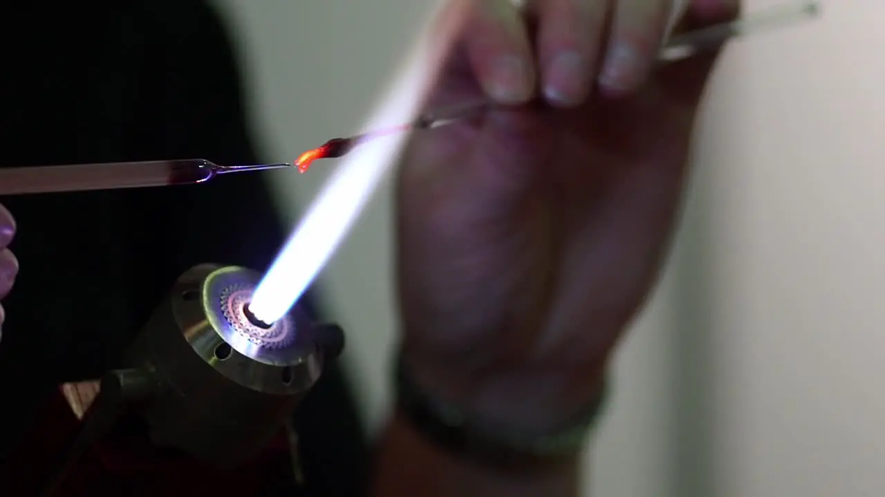 Close Up Of Blowtorch Flame And Hands Holding Elements Being Heated