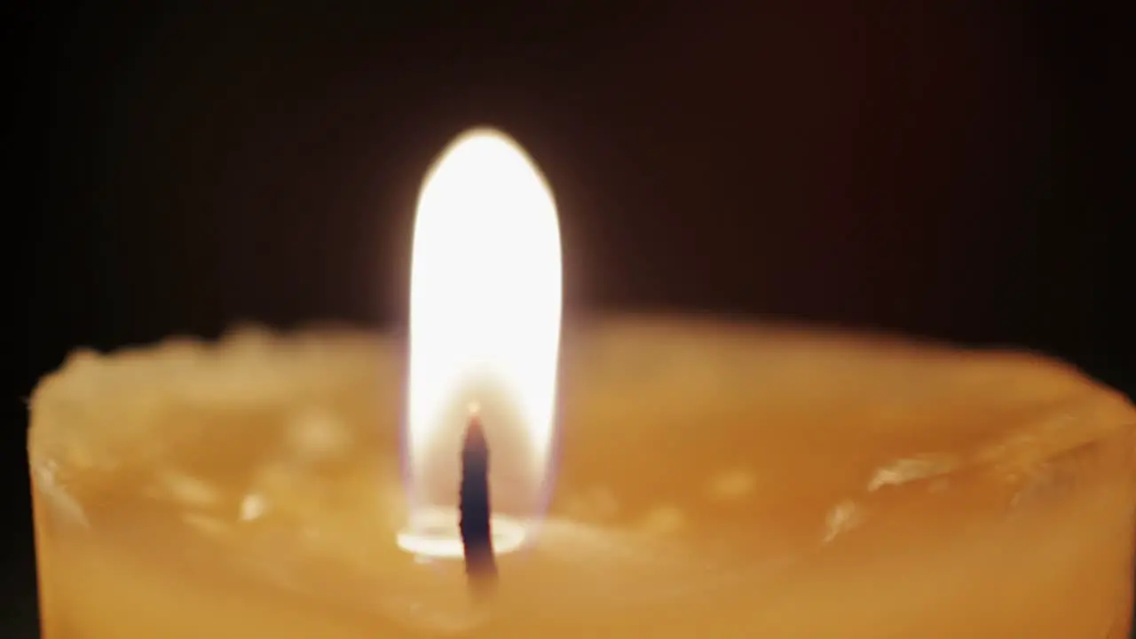 Macro shot of a candle dancing in the wind