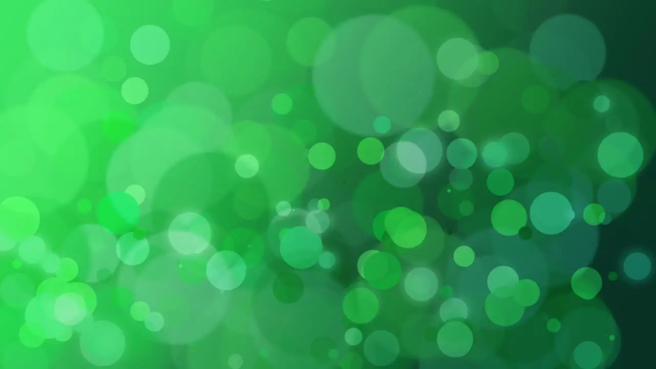 Abstract green bokeh and particles falling with