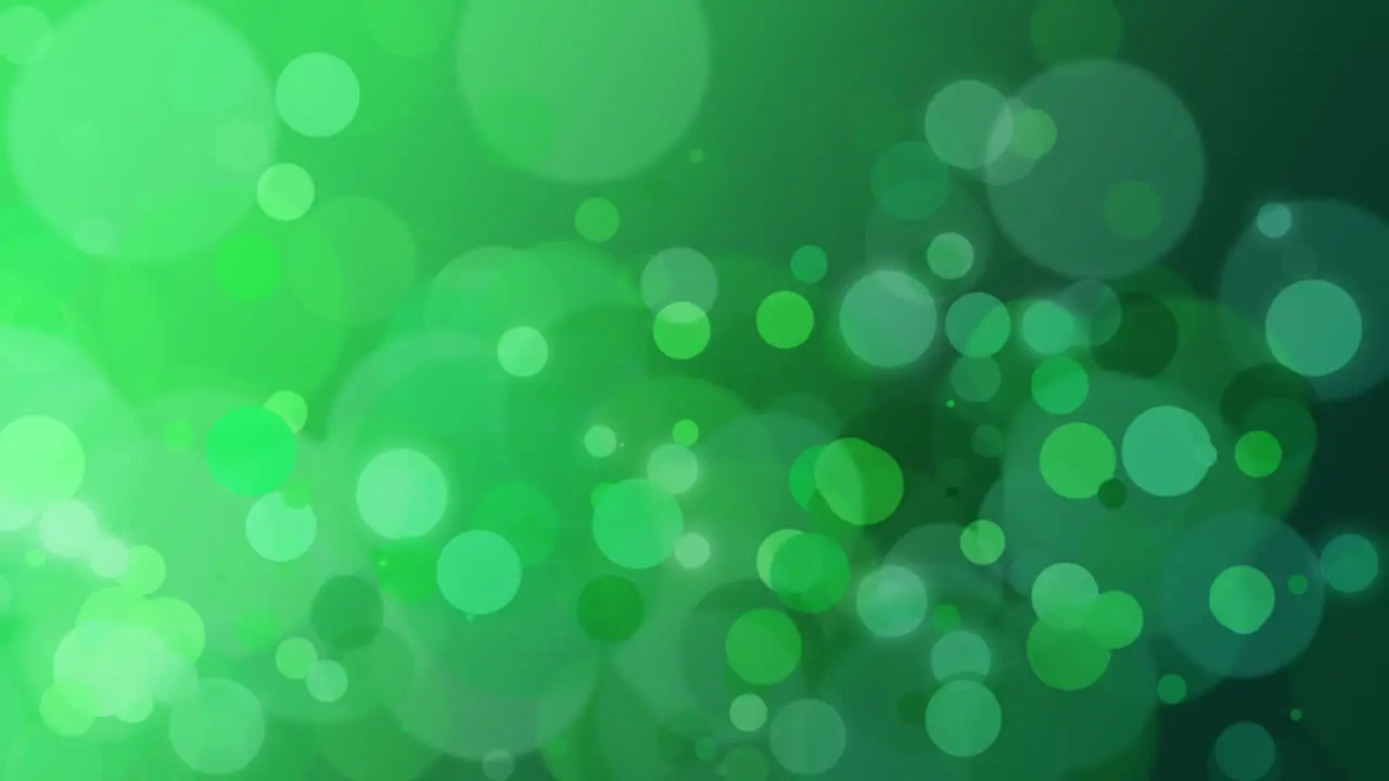 Abstract green bokeh and particles falling