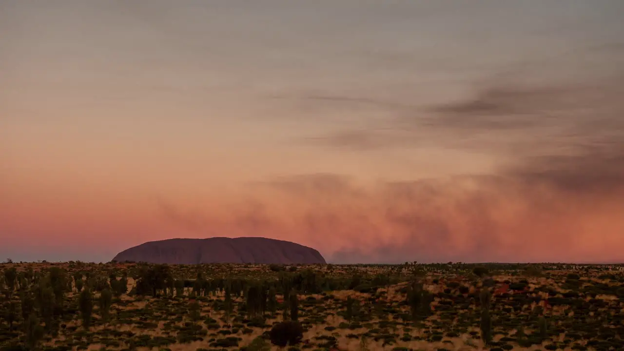 A time lapse of smoke from controlled bush fires blowing around Uluru in the Northern Territory Australia