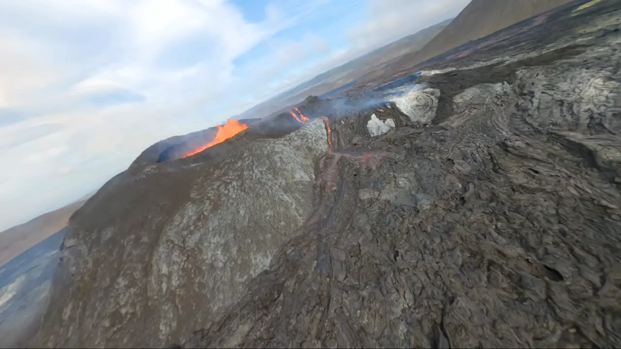 FPV drone perspective of Fagradalsfjall volcano in iceland while it dives over the lava crater