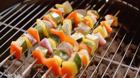 Four vegetable kabobs on grill