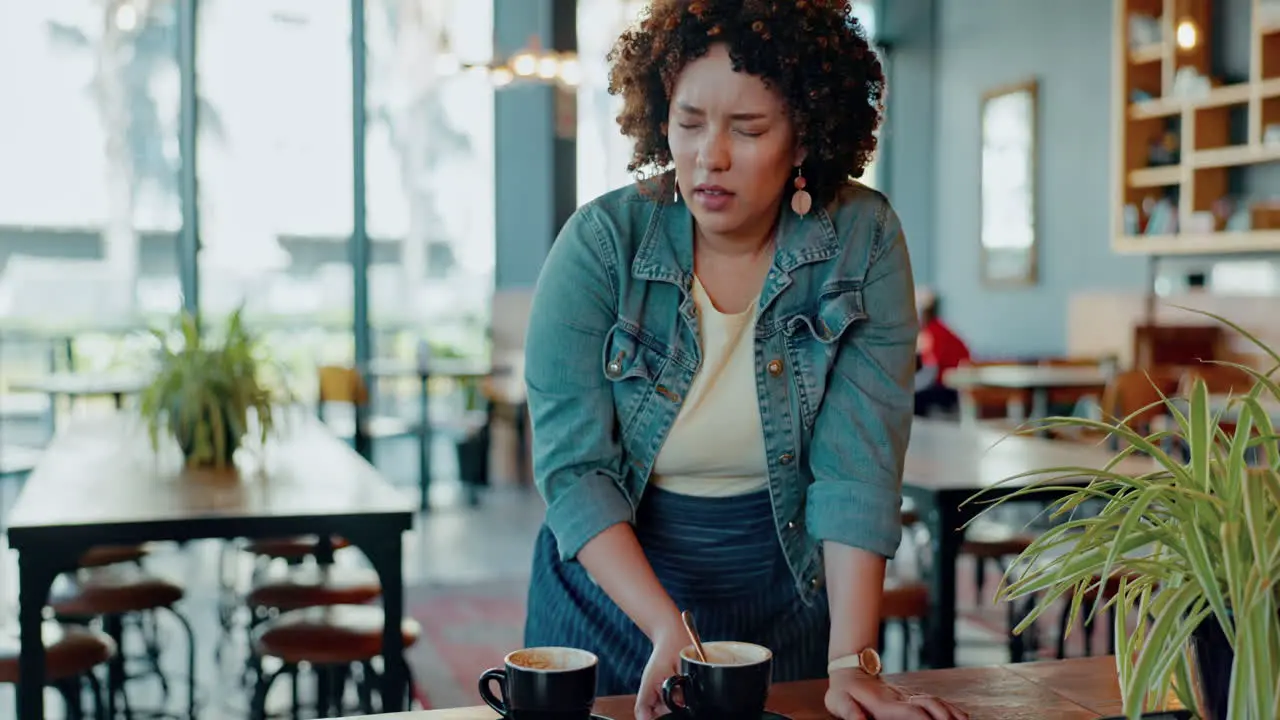 Tired headache and woman barista in a coffee shop