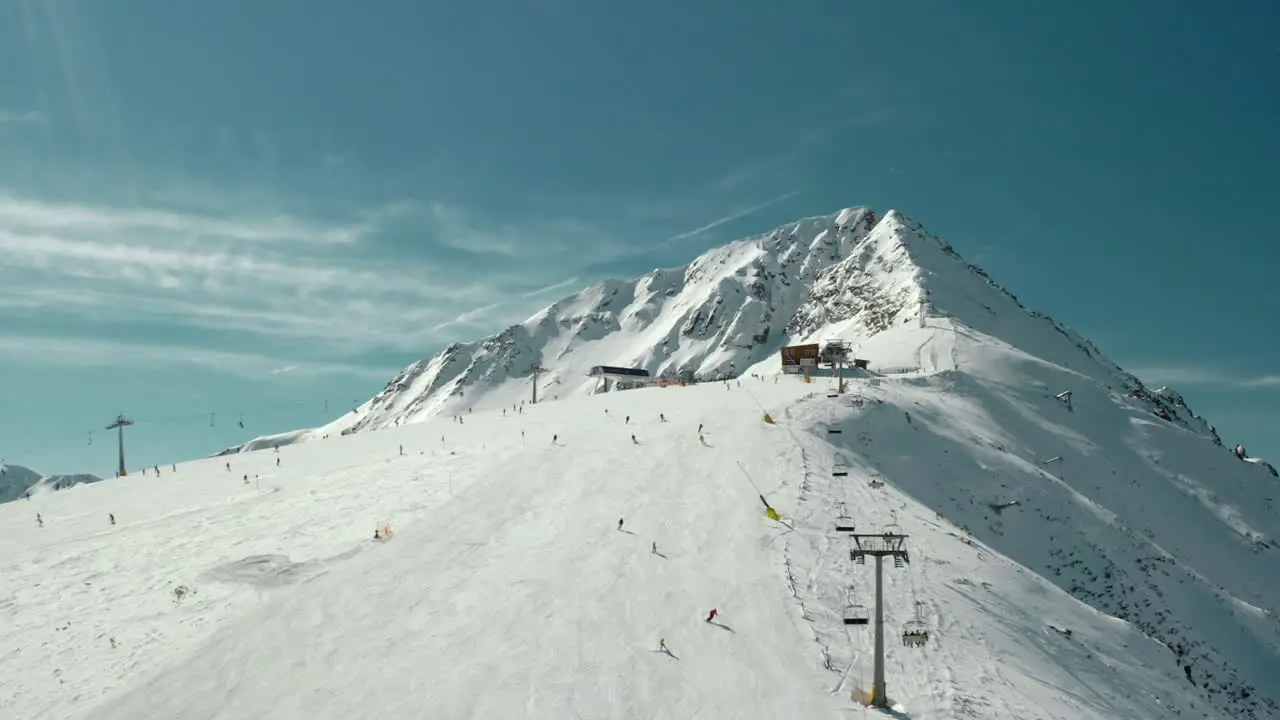 Chairlift on Ski Slopes on Snow-Covered Mountains Aerial Drone View