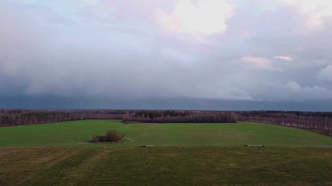 Autumn storm clouds gliding above countryside landscape aerial view