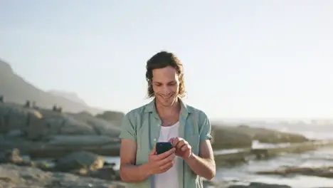 Happy man cellphone and beach vacation