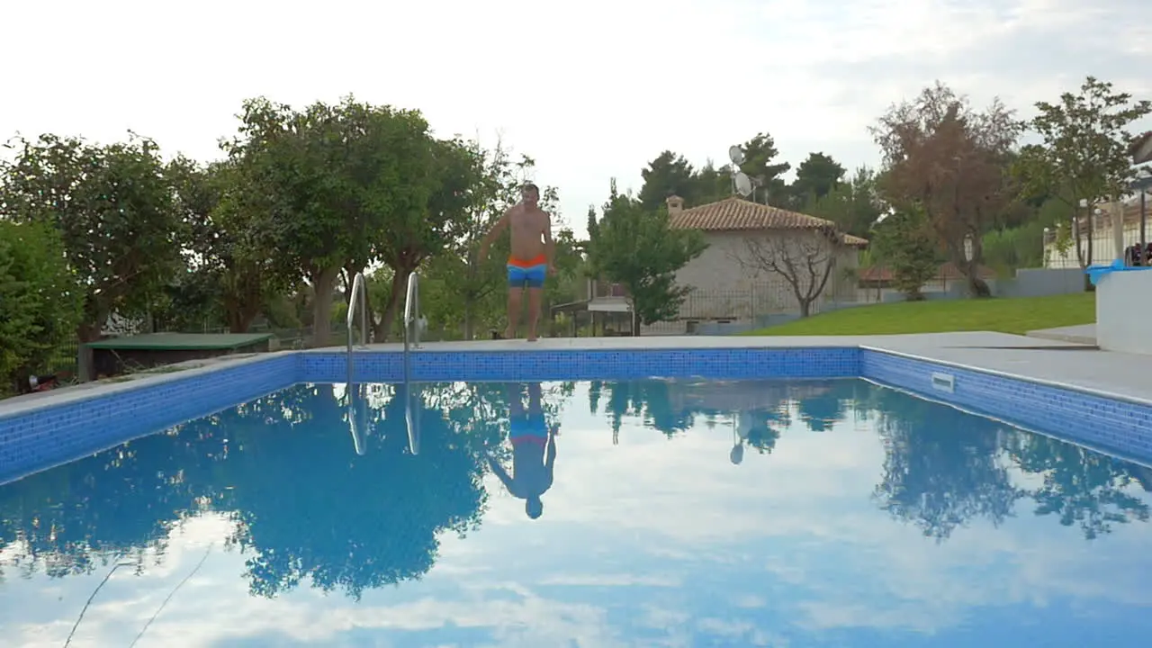 Man jumping into the outdoor pool