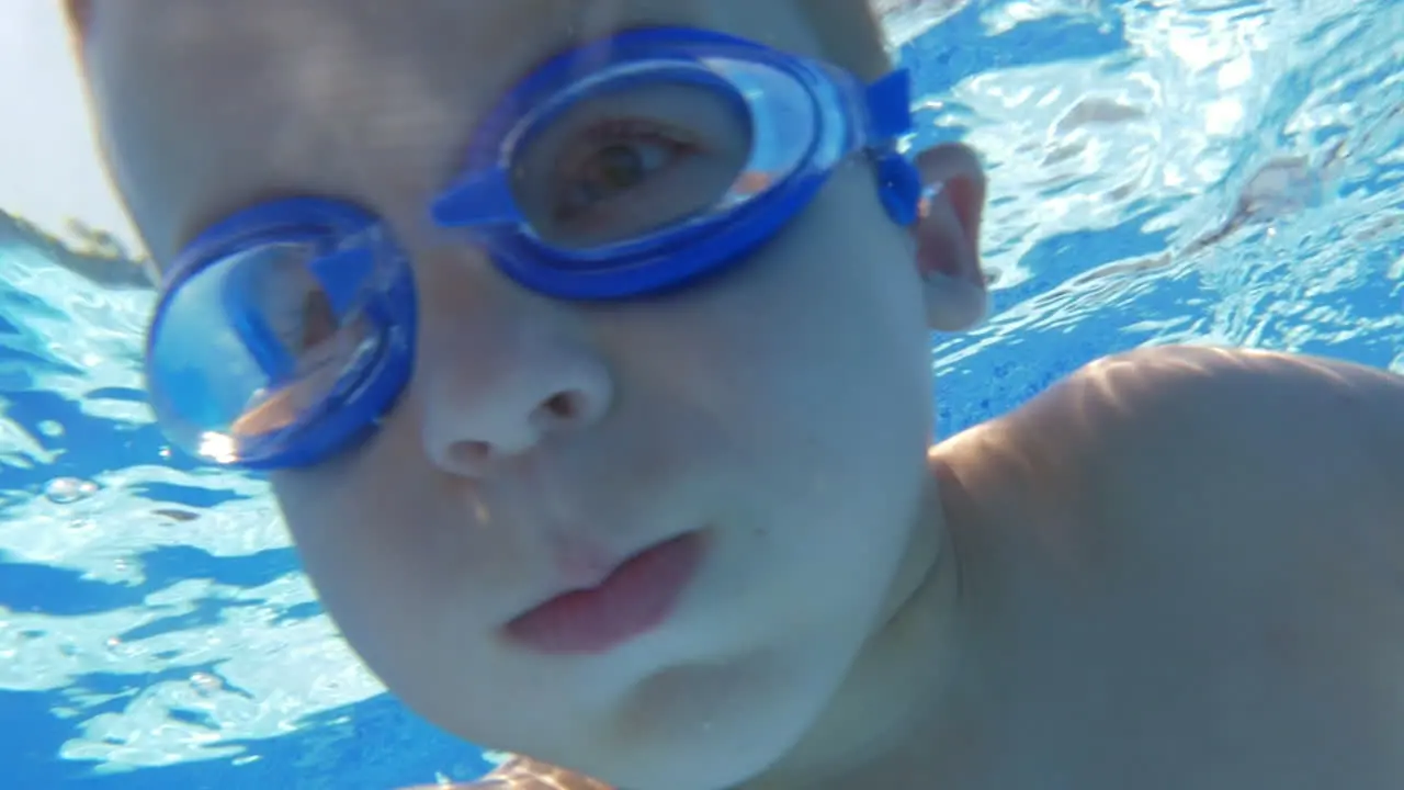 Underwater swimming of a child in goggles