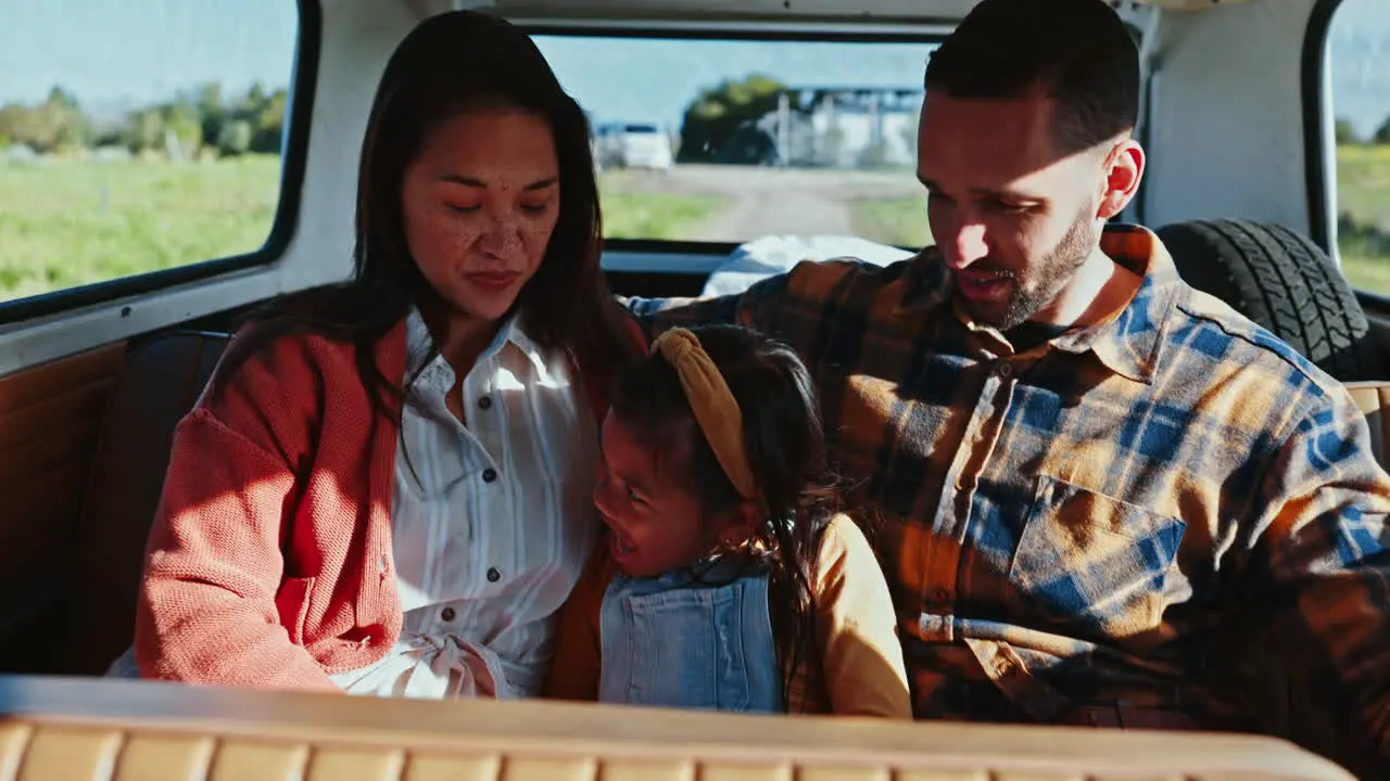 Laugh parents and girl in car for road trip