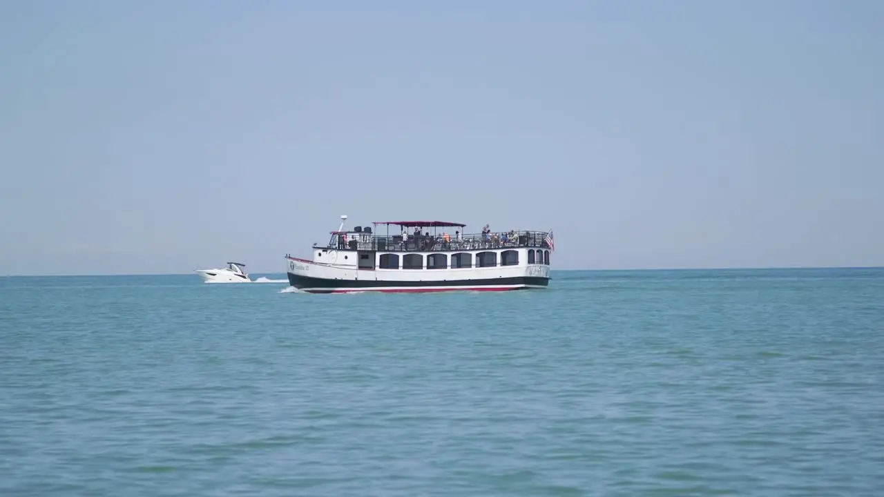 People On Boat In Lake Passing By Beach