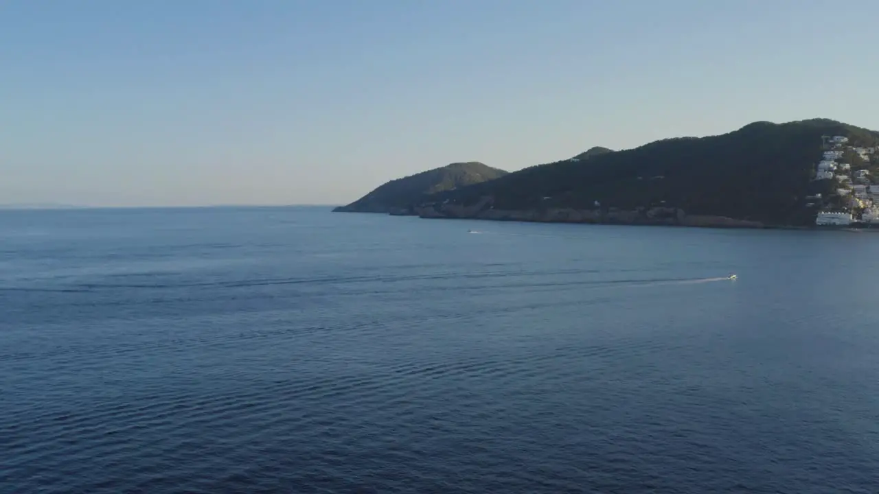 Open sea with mountains island of Ibiza in the back