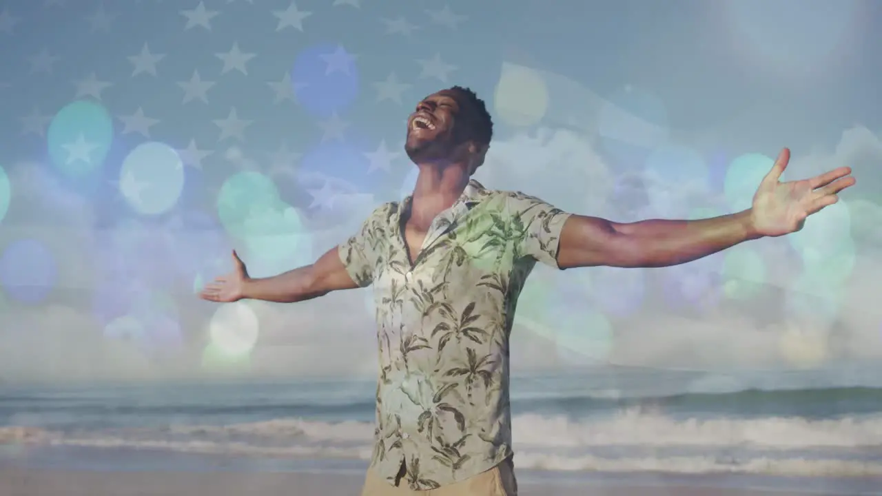 Spots of light against african american man with arms wide open enjoying on the beach