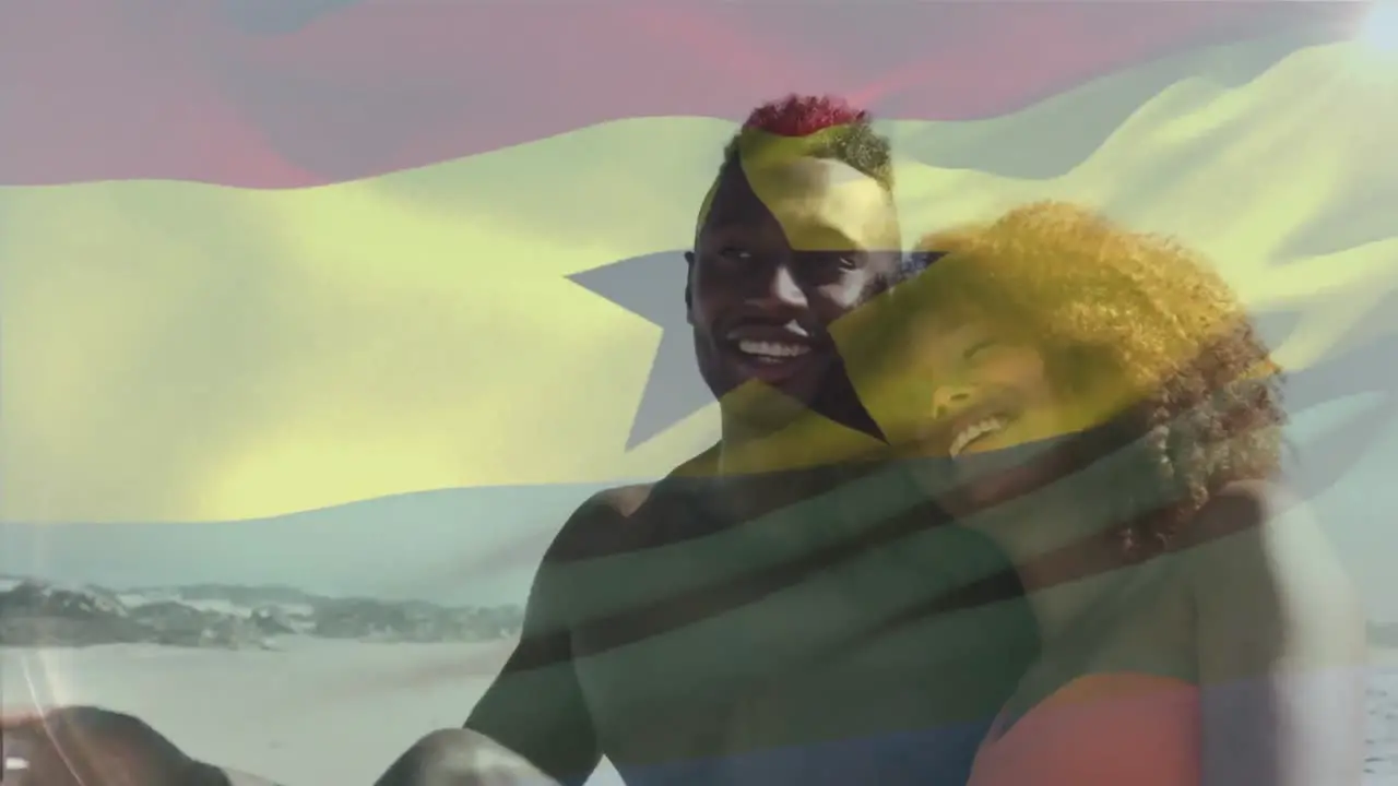 Animation of flag of ghana over african american couple at beach