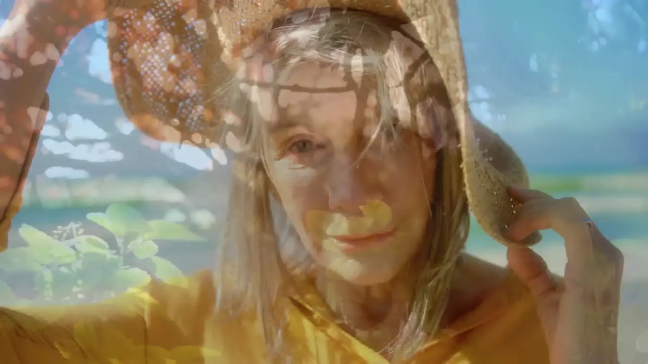 Composite video of caucasian senior woman wearing a hat smiling against plants in the garden