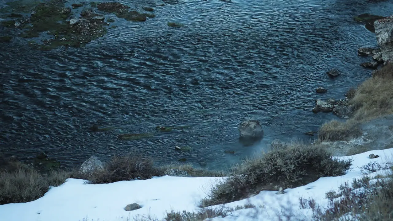 Hillside with Snow and Steam from Hot Springs Hot Creek Geological Site California High Angle