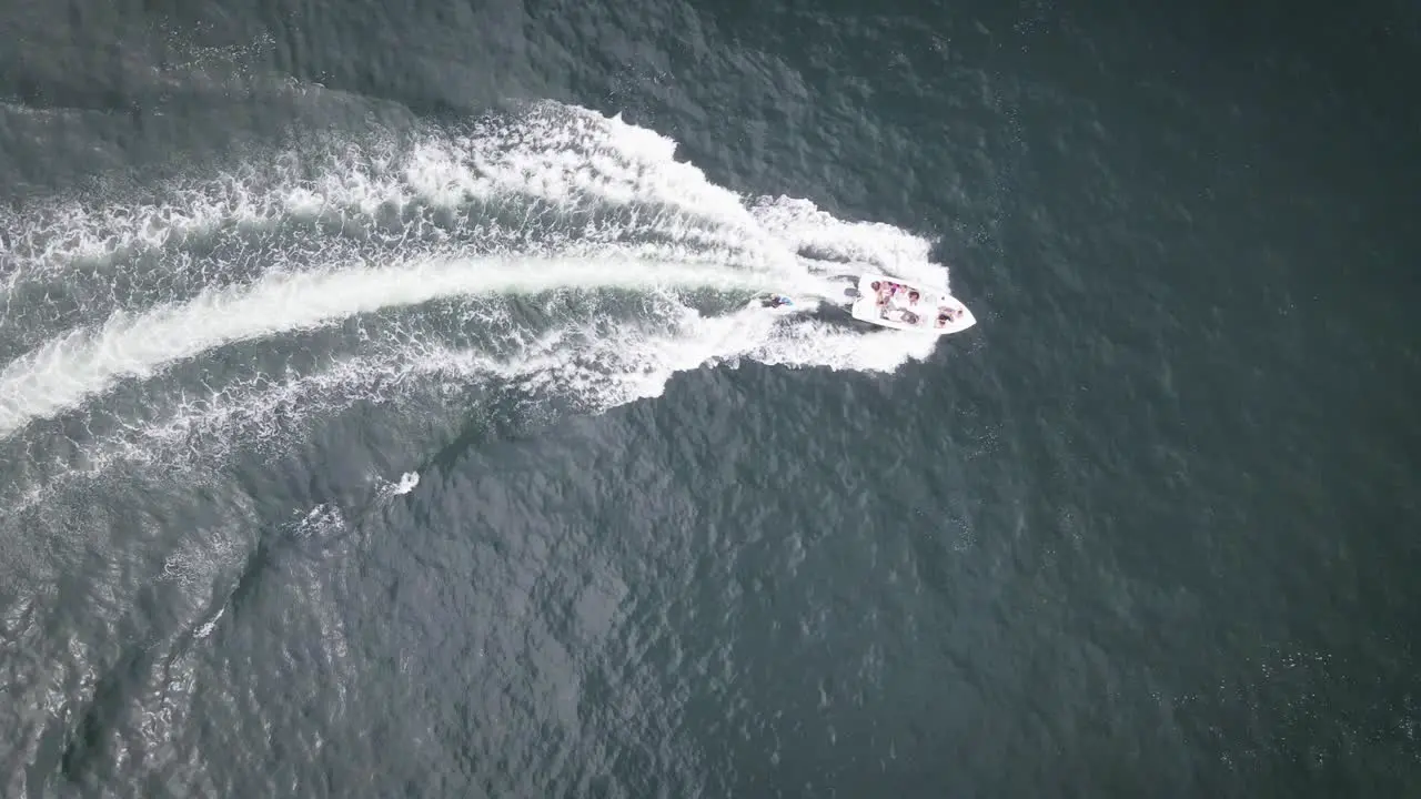 Top down shot of friends on a boat wakeboarding in the summer