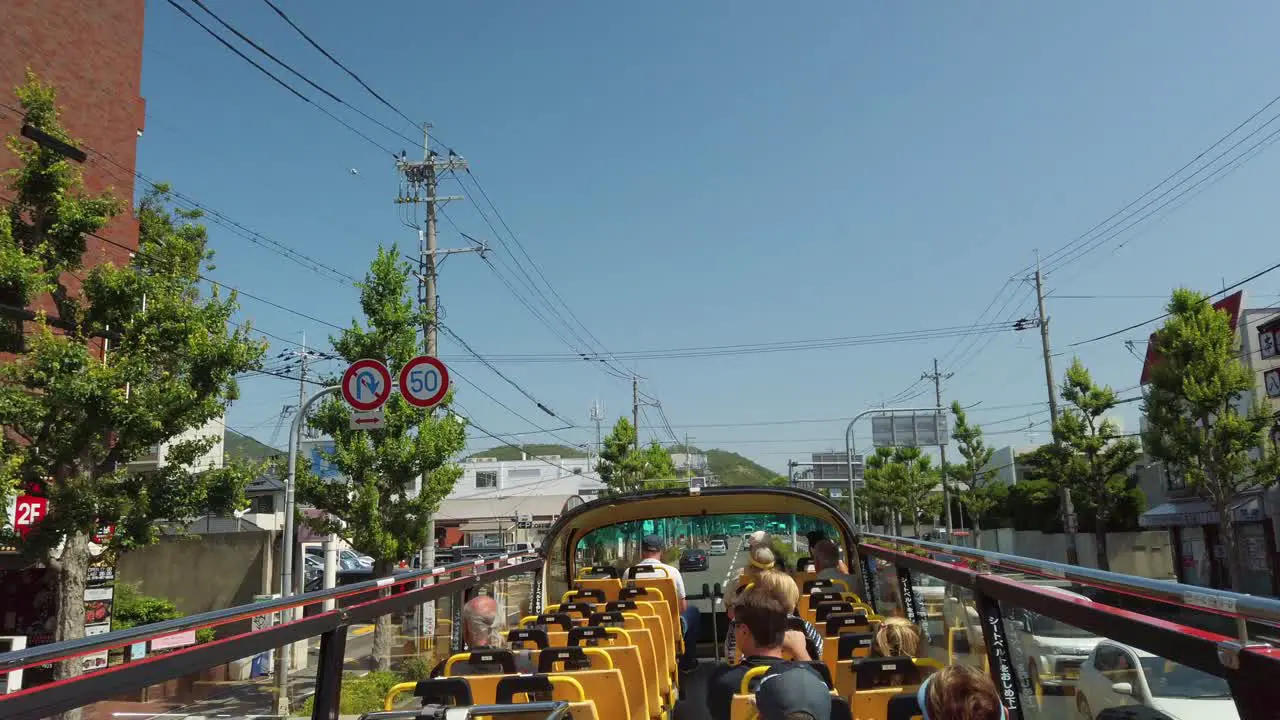 Touristic hop on hop off bus tour with open double decker through the Japanese city of Kyoto