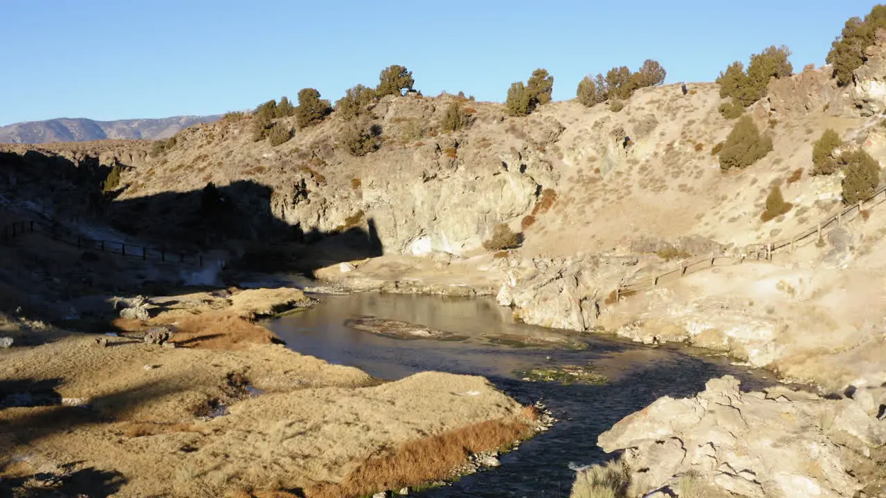 Flyover Water Stream and Hot Spring Famous Landmark Hot Creek Geological Site Aerial