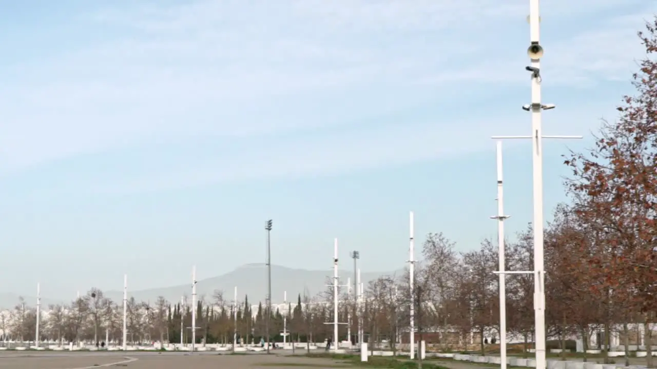 Slow motion pan establishing shot of Athens Olympic Stadium on a cloudy day during coronavirus lockdown restrictions