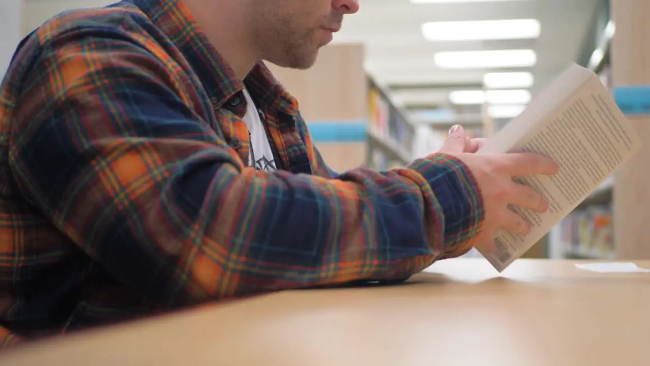 Man flipping through the pages of a book