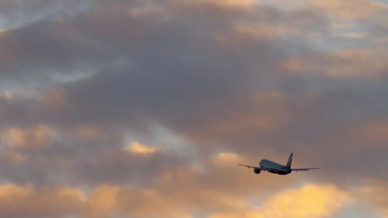 Airplane flight in cloudy evening sky