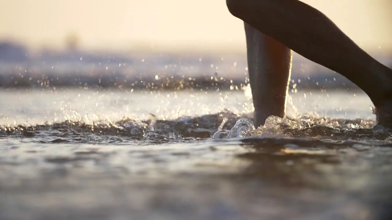 Walking Through Surf and Kicking Up Spray