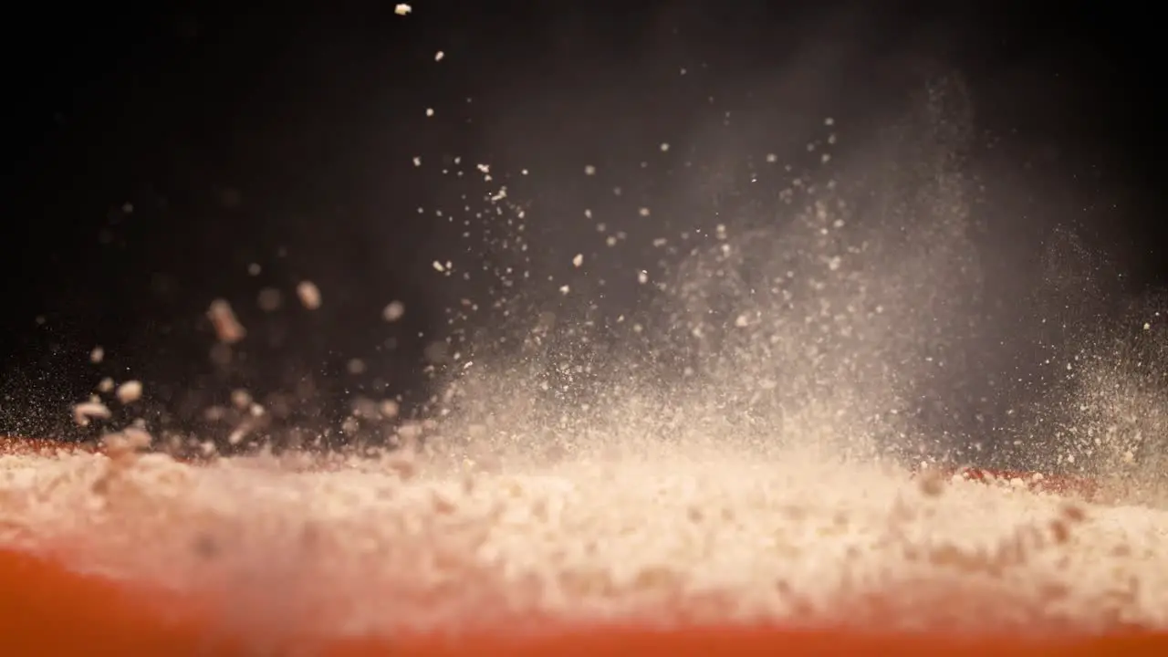 Powder explosion on orange and black background in super slow motion