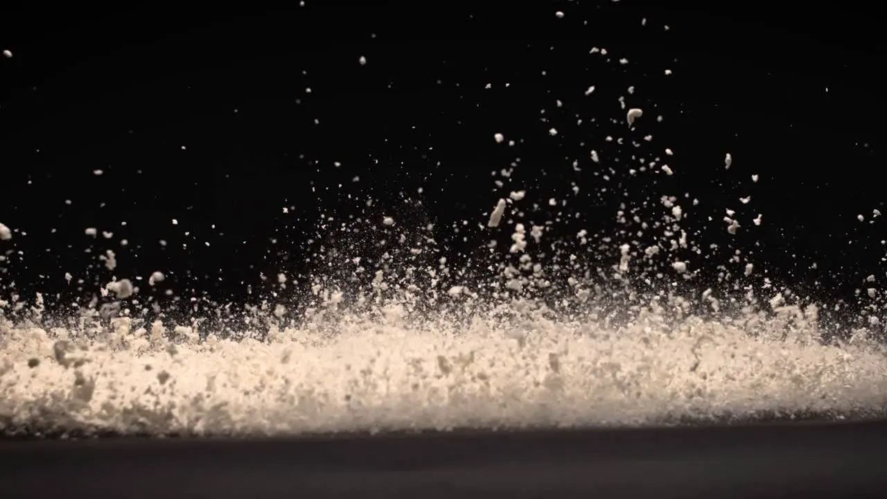 White Powder explosion on black surface super slow motion 800fps high speed