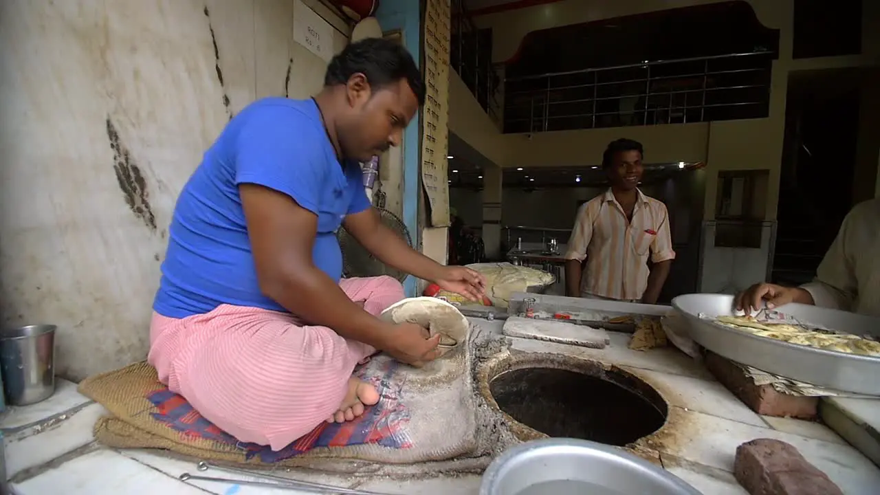 Man Puts Naan in a Bread Oven