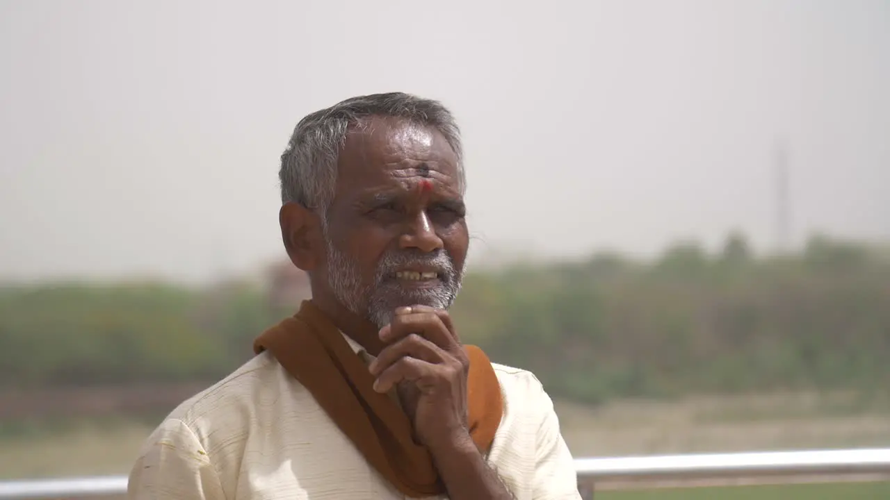 Elderly Indian Man Rubbing His Beard