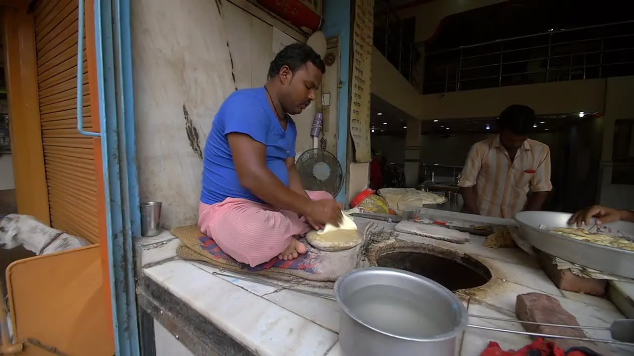 Slow Motion Shot of Man Cooking Naan in an Oven