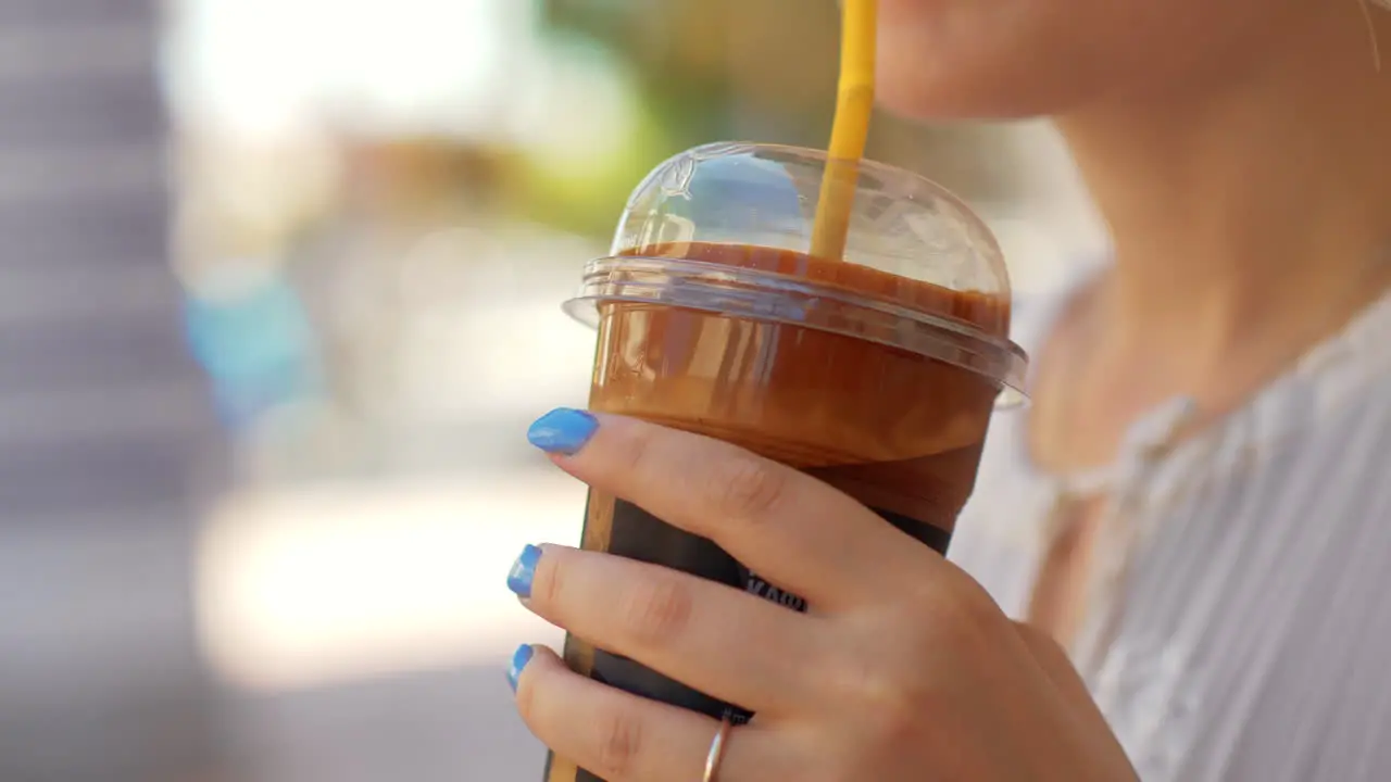 Woman drinking chocolate cocktail in the street