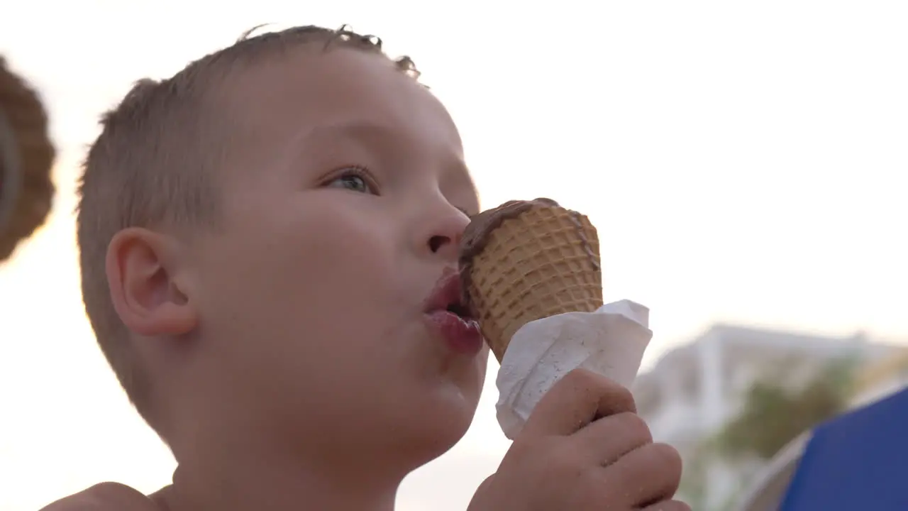 Child eating chocolate ice cream outdoor