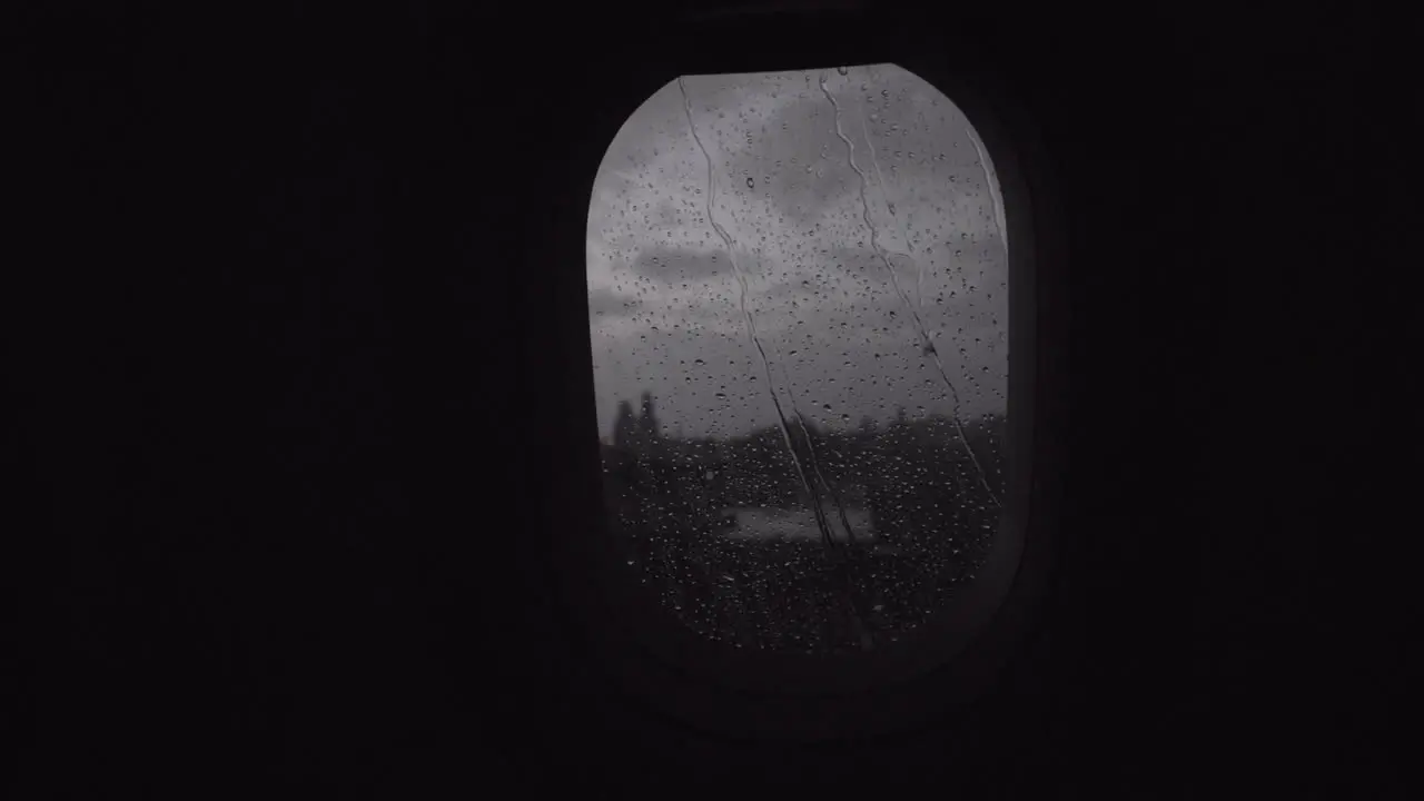 Flying by plane in rainy evening view through the illuminator