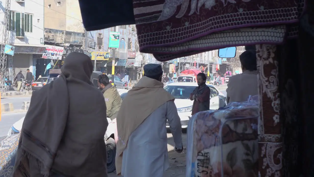 Locals Walking Past On Pavement With Traffic Going Past In Quetta Balochistan